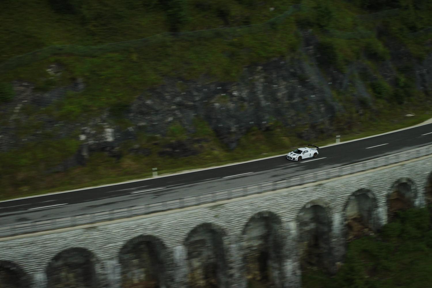 Black and white XGT from a distance from the side view on a bridge