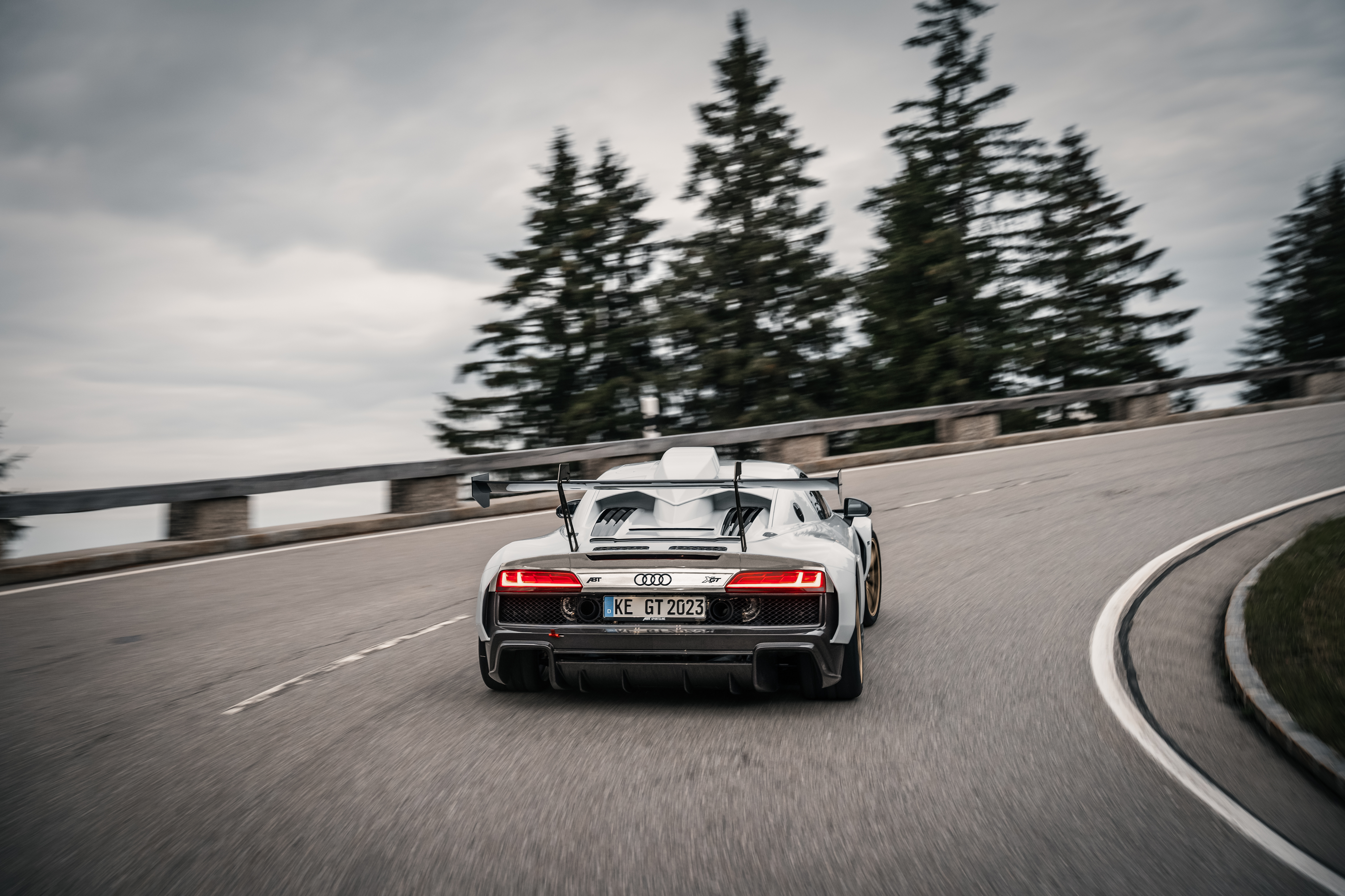 Black and white XGT from the rear view while driving on the road 