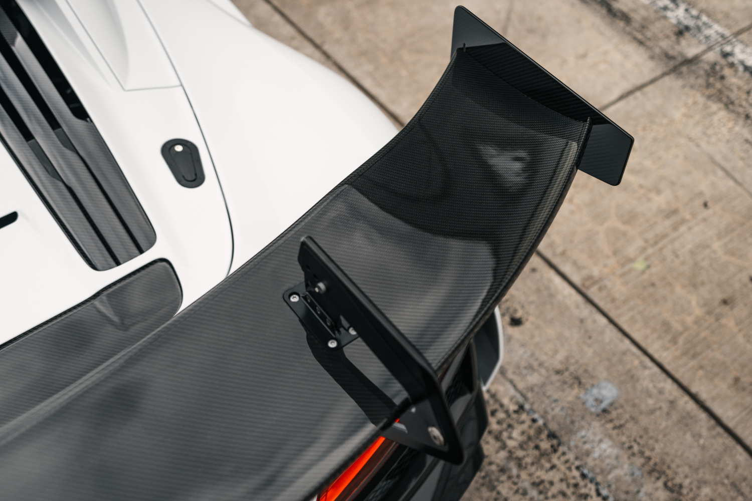Close-up rear spoiler from above of a black and white XGT