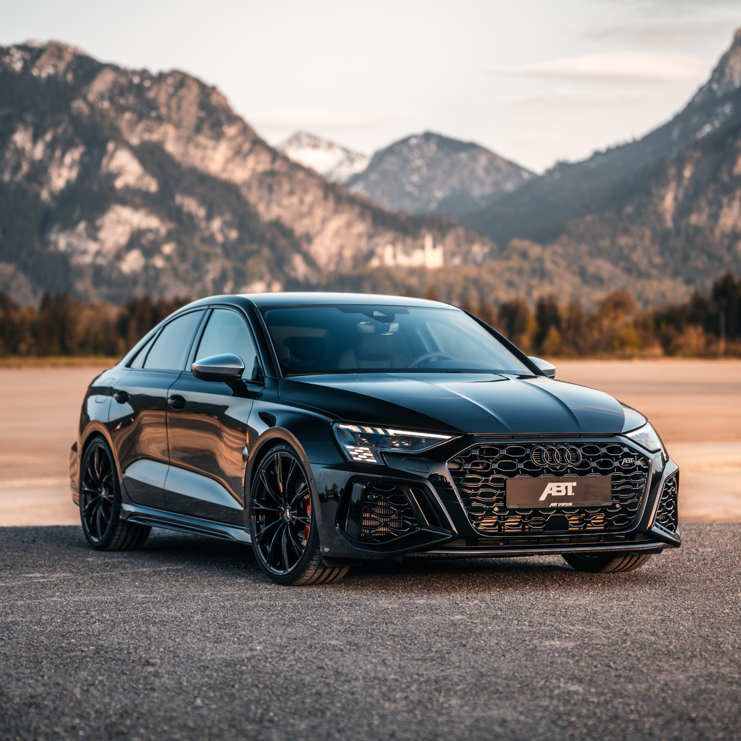 Black RS3-S from the side front view in front of a mountain panorama