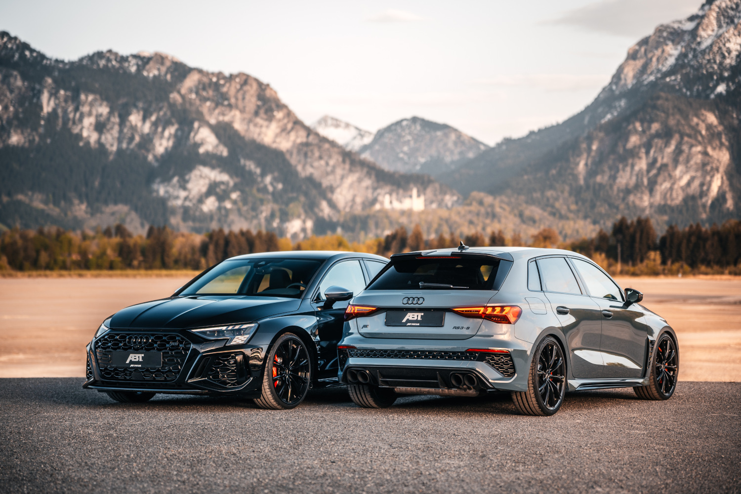 two blue RS3-S next to each other forwards and backwards in front of a mountain panorama