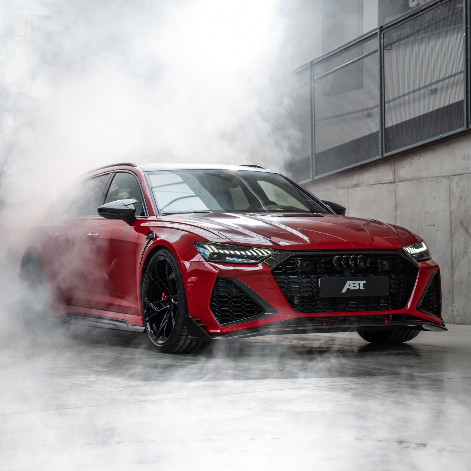 Red RS6-LE from the side front view in hall with fog