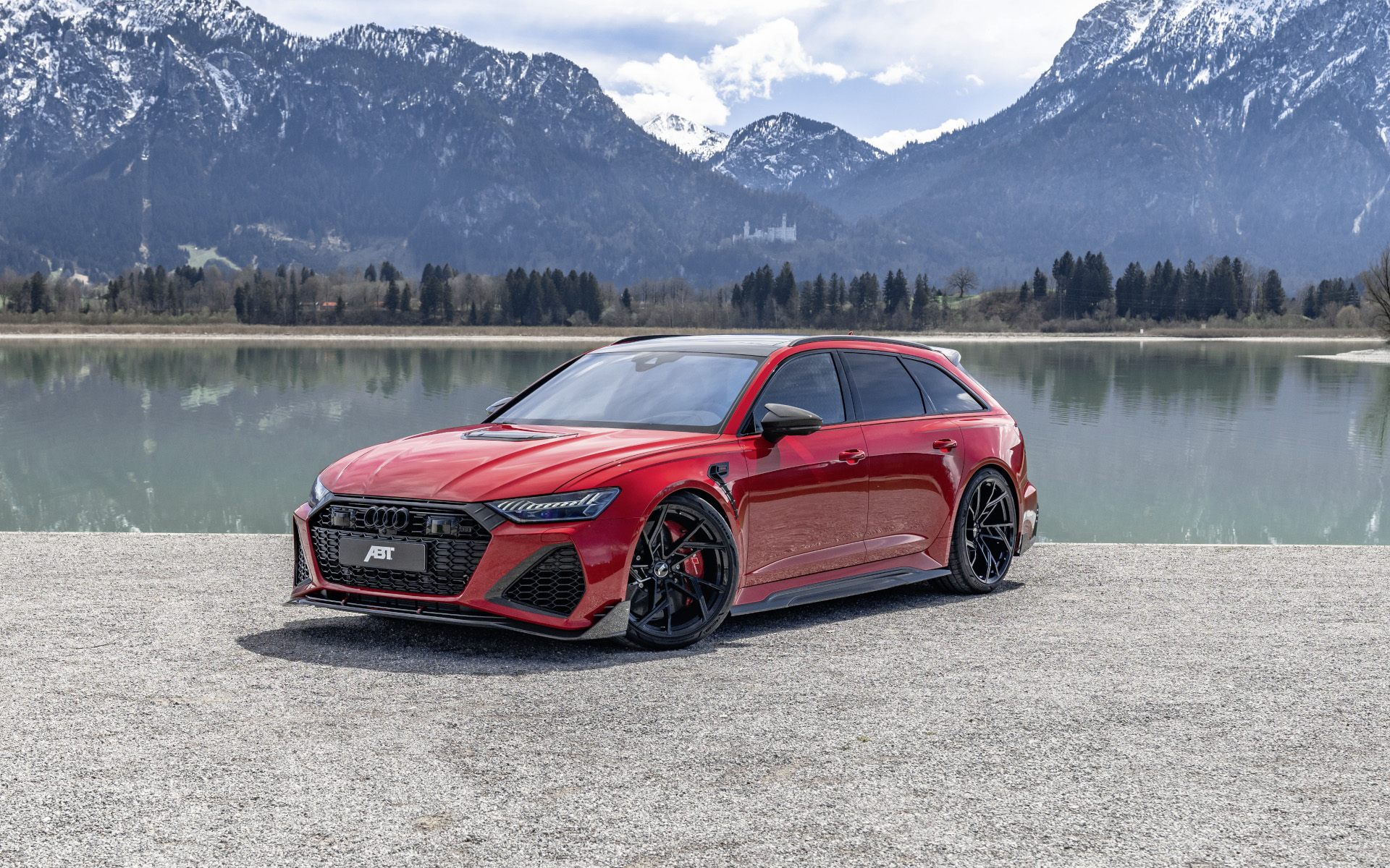 Red RS6-LE from the side front view in front of the lake with mountain panorama