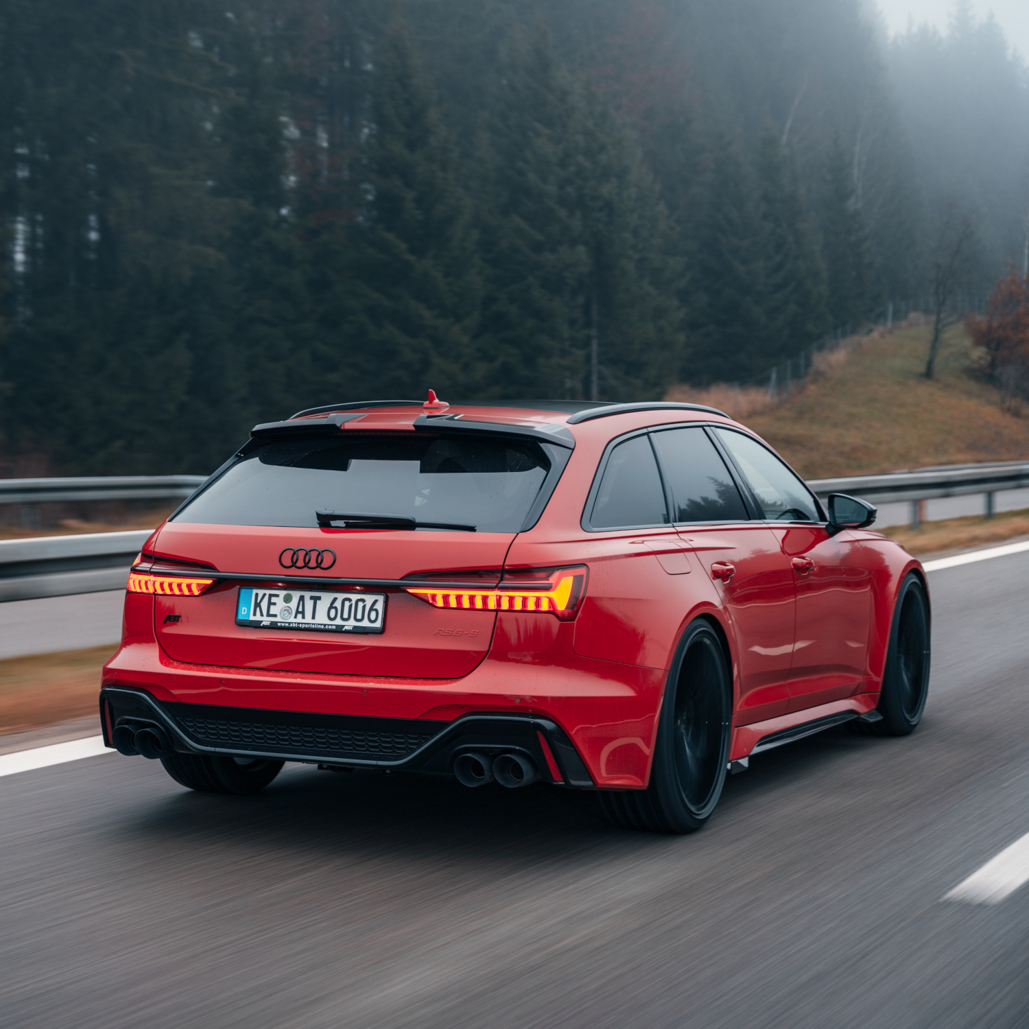 red RS6-S from the side rear view while driving 