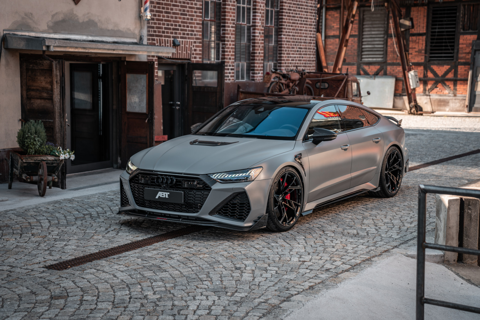 grey RS7-LE from the side front view in front of the building