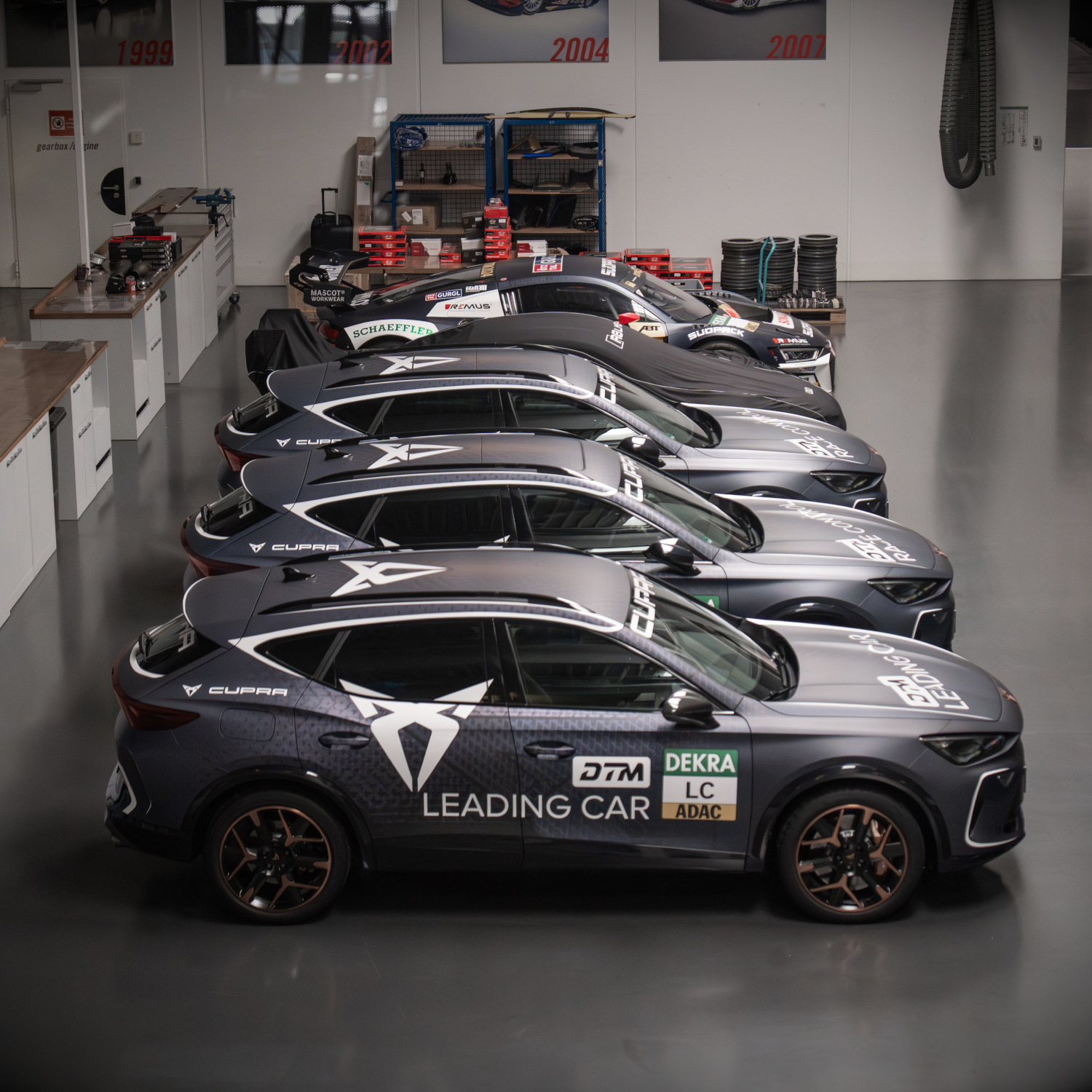 Side view of all DTM safety cars in the motorsport hall
