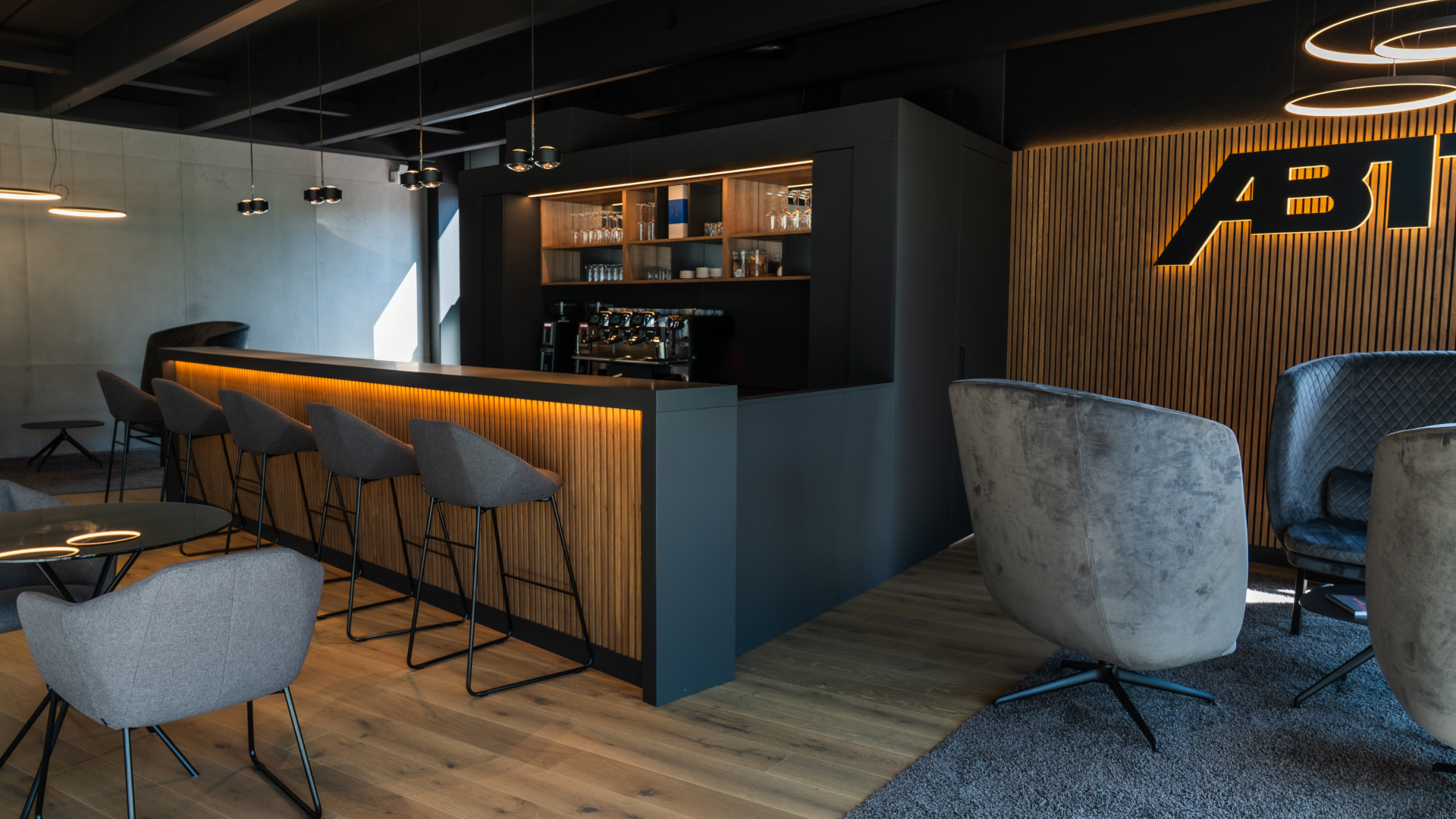 View from the bar of an ABT S5 and an RS6-LE standing in the Signature Lounge